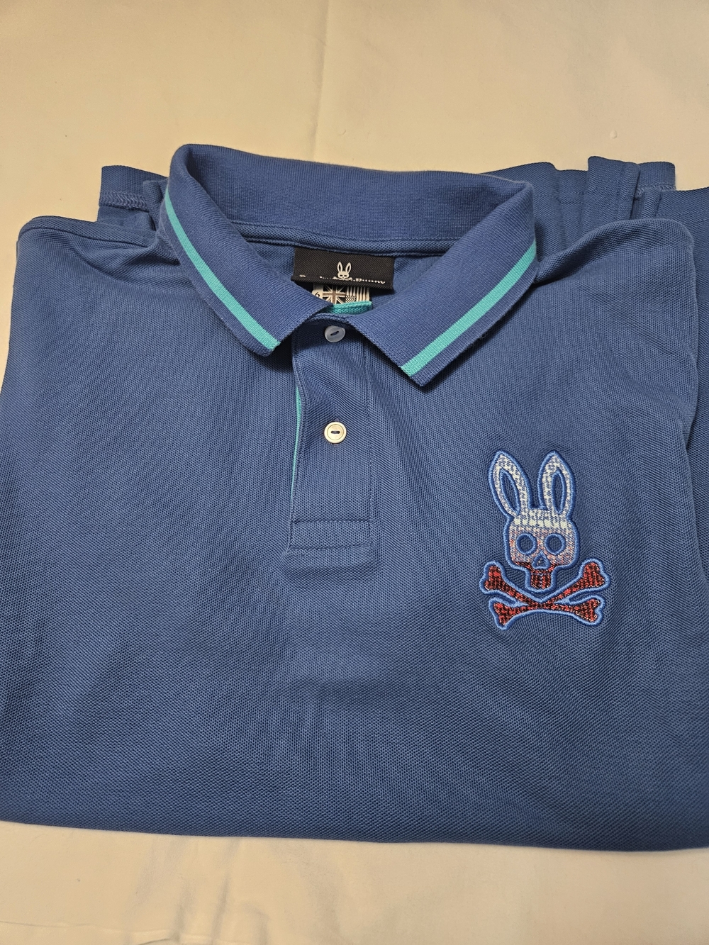 Psycho Bunny Blue Polo with Turquoise Trim and Bunny Skull Patch